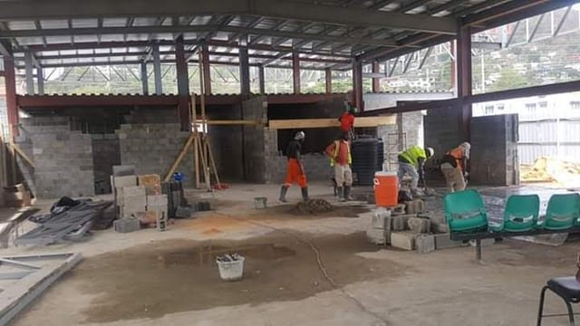 A Jamaal's Industrial crew laying blockwork inside a steel-framed building under construction