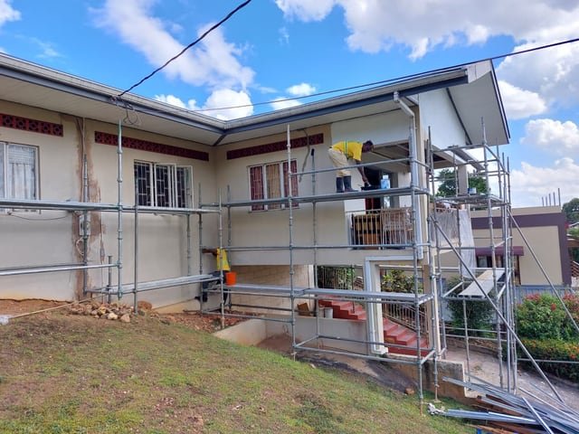 A Jamaal's Industrial team refurbishing a house behind full scaffolding on a general contracting project